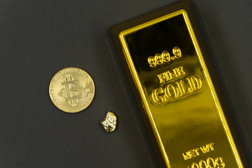 Bitcoin next to a gold bar
